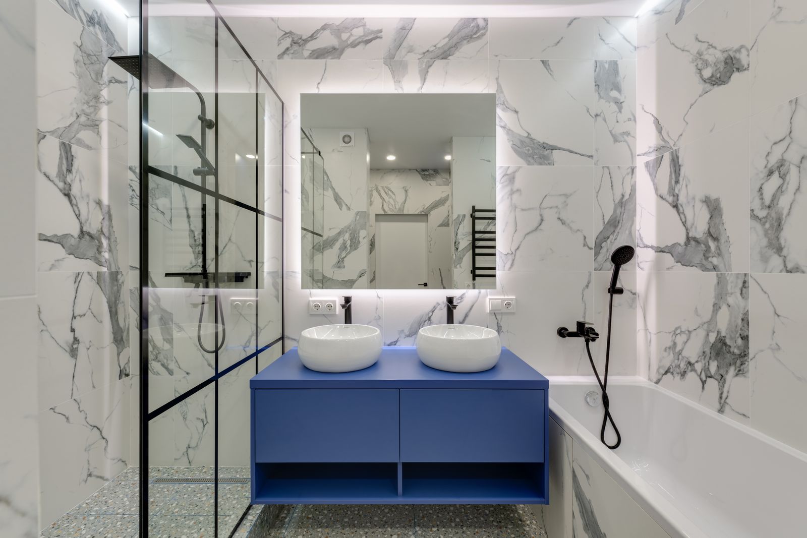 Luxury renovated bathroom with glass walk-in shower and dual vanity