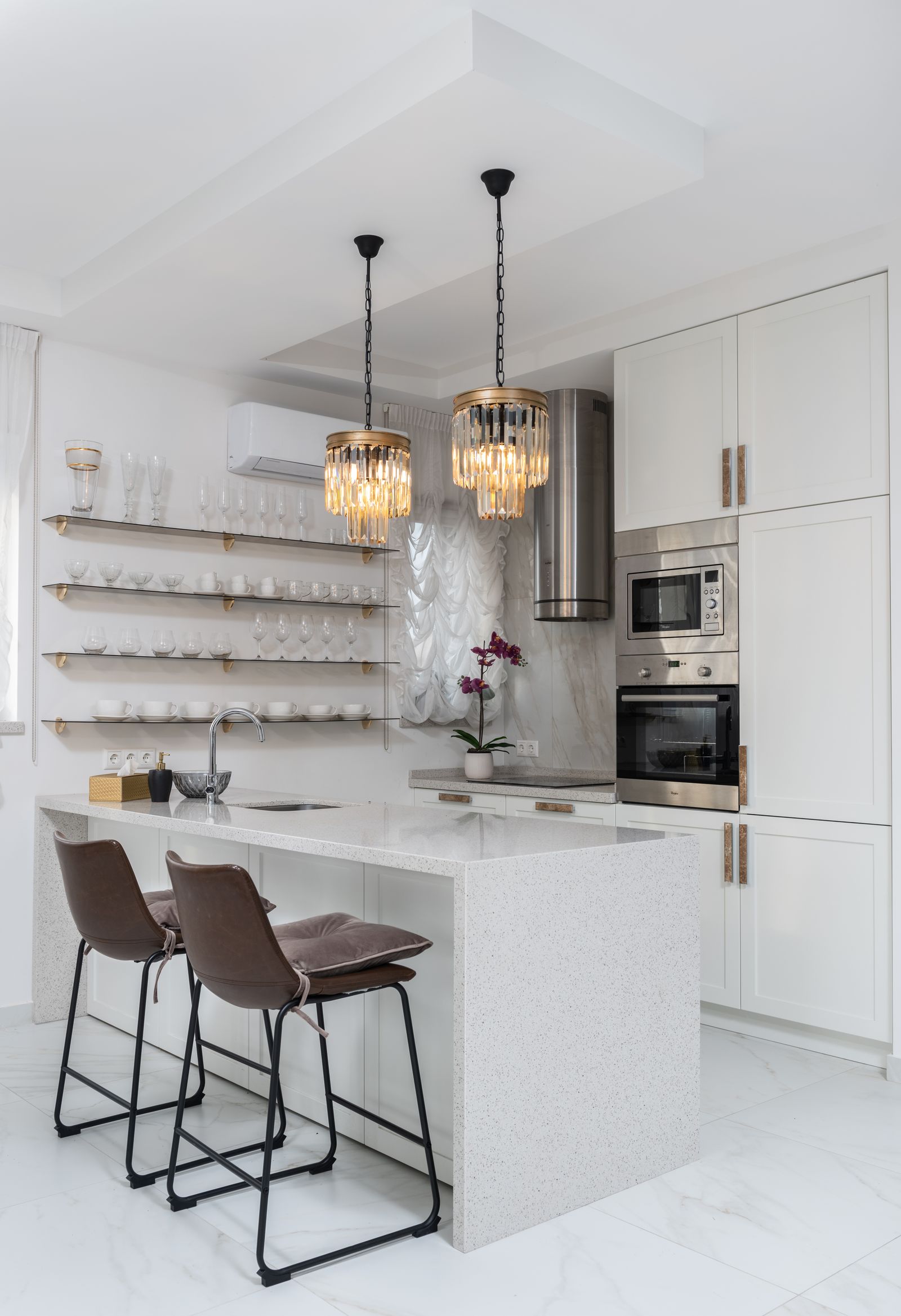 Renovated modern kitchen with island, custom cabinetry and pendant lighting