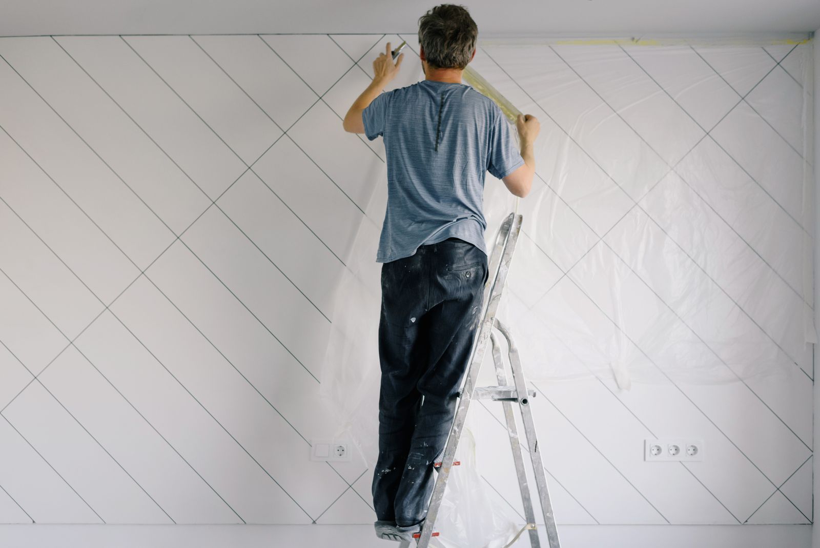 Professional painter finishing a bright interior wall