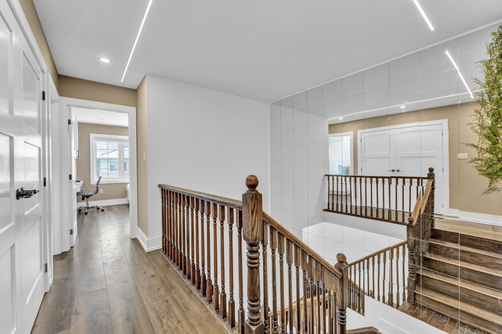 Gallery hallway with mirrored walls and solid core doors by Eagle Eye Home Renovations