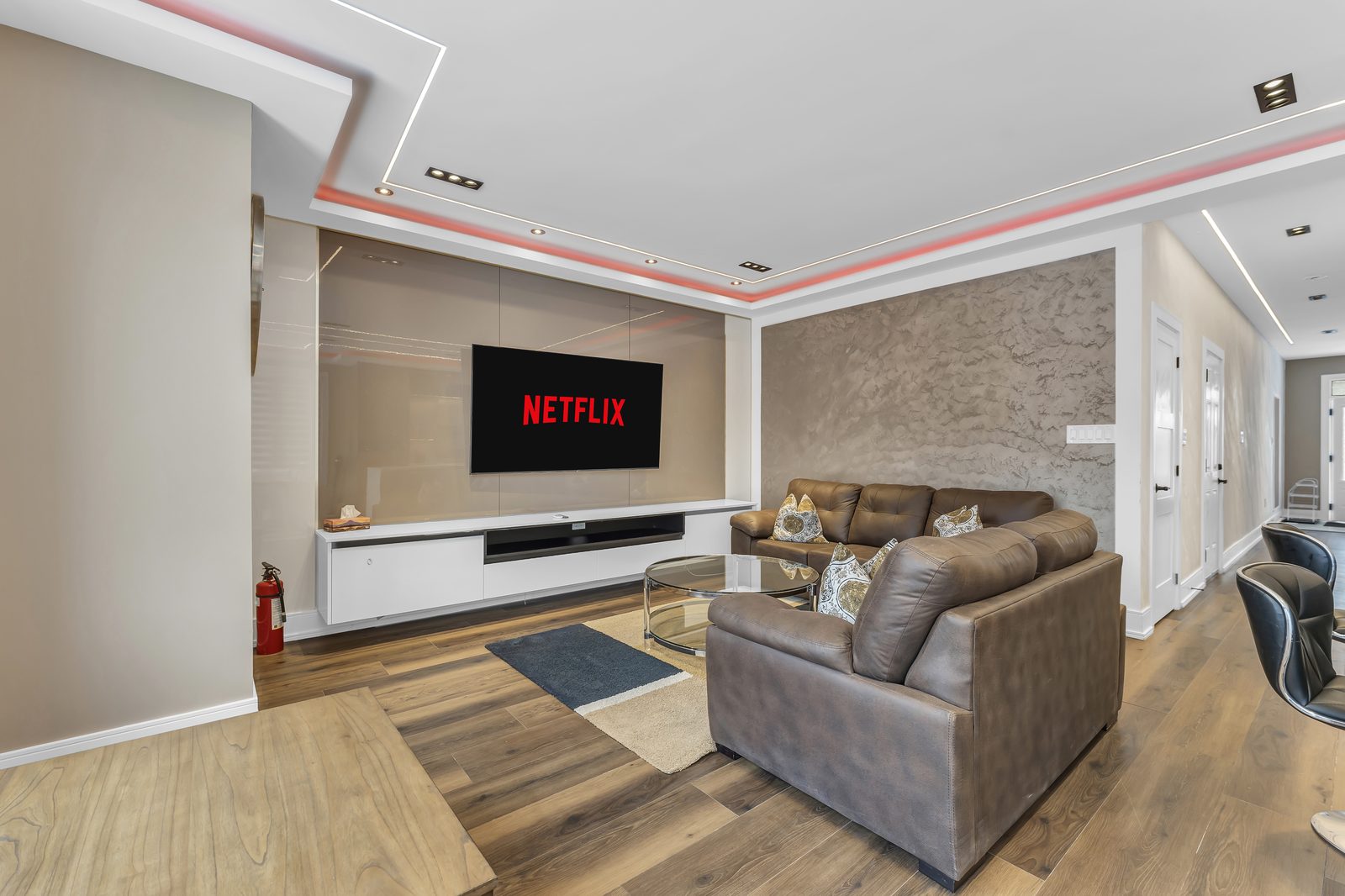 Living room with accent walls, drop ceiling and strip lighting by Eagle Eye Home Renovations