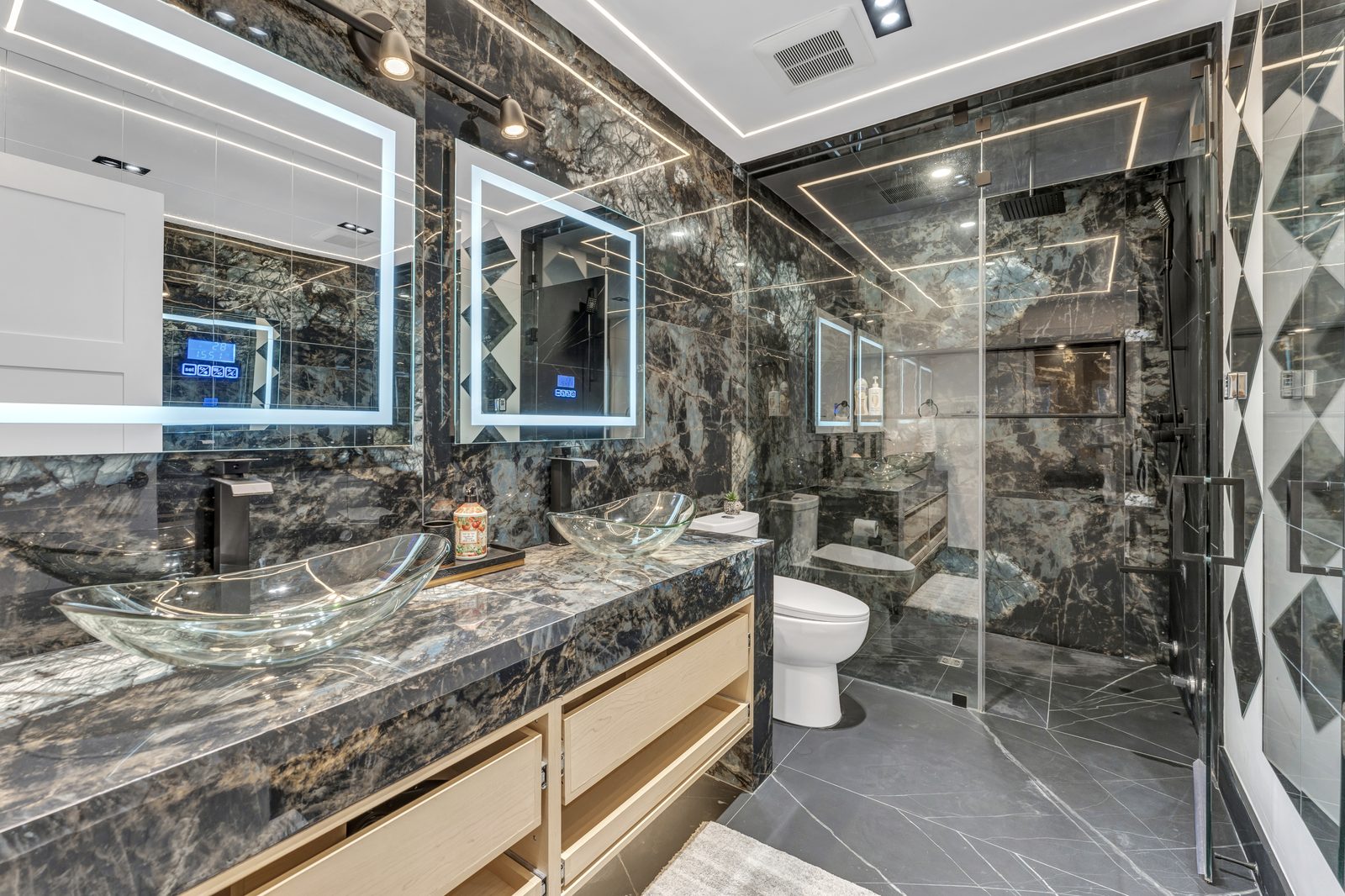 Black-marble master washroom with LED-lit shower by Eagle Eye Home Renovations
